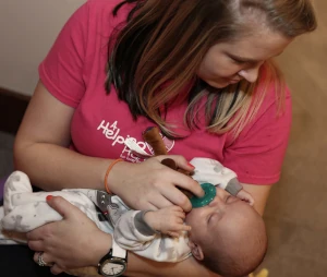 Helper feeding a baby