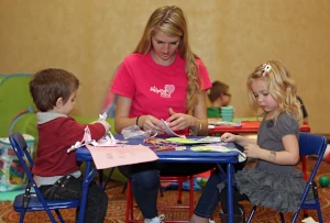 Helper and children doing homework